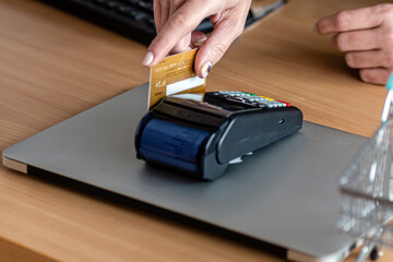 woman using payment terminal, paying with credit card, credit card reader, finance concept