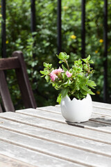 flowers in a vase on a garden table 