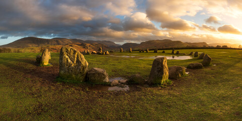 Panoramic view of dramatic sunset at Castlerigg Stone Circle, Keswick, Lake District, UK.