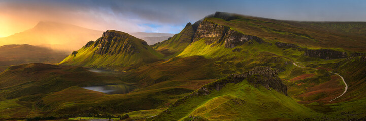 Epic panoramic view of Hebrides mountains on The Trotternish Ridge with incoming rain shower and beautiful golden light. Quiraing, Isle of Skye, Scotland, UK. - 495417958