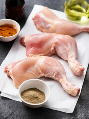 Skinless Raw chicken legs on white paper. Raw chicken legs for barbecue or soup. Fresh raw chicken legs.