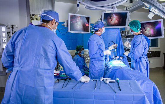 Multi ethnic medical healthcare team performing laparoscopic surgery