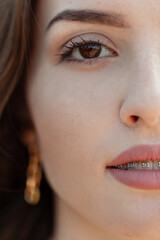 Closeup portrait of beautiful Caucasian teenager woman model with brown eyes, clean skin and dental...