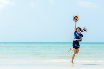 Summer Vacation. Lifestyle woman walking and jumping relax happy on beach tropical outdoor in...