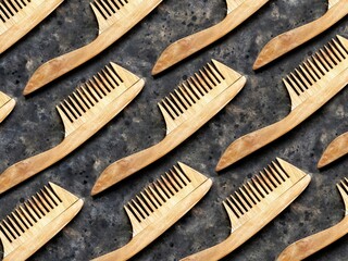 Pattern of wooden comb on a black concrete background