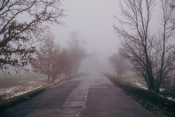 Fototapeta na wymiar asphalt road in the fog, vintage effect