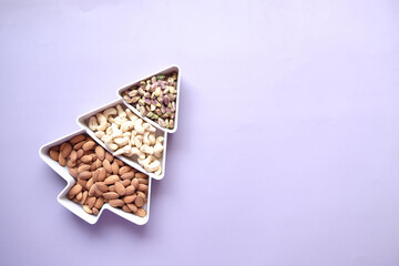 walnut , cashew nut and almond in a container on table 