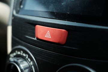 Emergency hazard light button icon on car dashboard