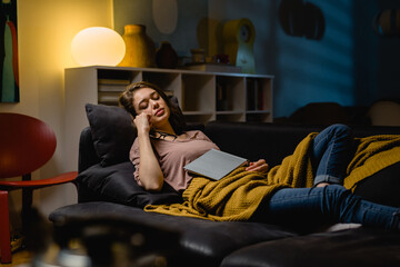 Fototapeta premium woman napping at home. she fell asleep while reading book