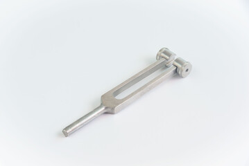 A tuning fork for neurological examination on white background.