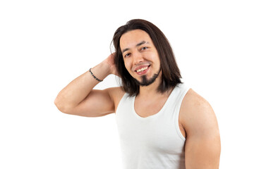 Handsome European bearded man with long hair looking at camera and smiling while wearing white tank top. Isolated medium studio shot over white background. High quality photo