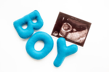 Ultrasound scan of unborn baby with letters boy