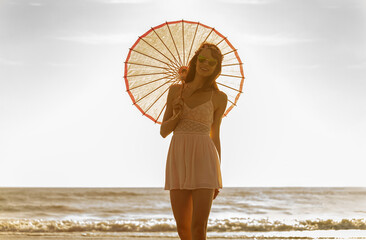 Young Caucasian girl with parasol for UV protection