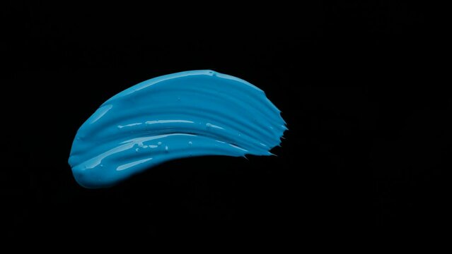 Brush painting blue on black background. High quality 4k footage
