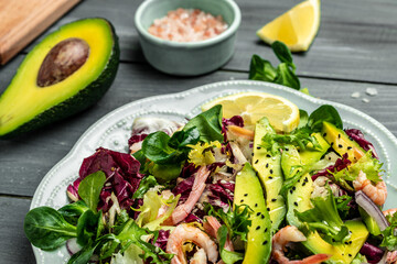 Seafood salad with shrimps, avocado slices and fresh greens, Healthy food. superfood concept. clean eating concept. Vegan or gluten free diet. top view