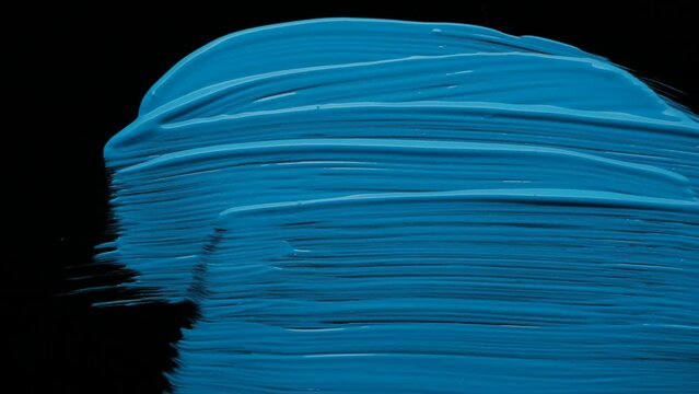 Brush painting blue on black background. High quality 4k footage