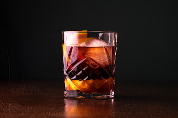 Negroni cocktail on wooden table and dark background