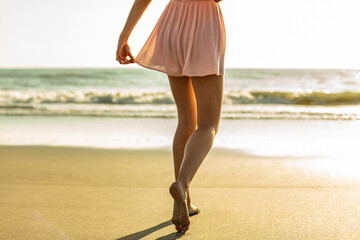 Young girl enjoying solo beach vacation at sunset