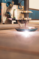 close-up laser cutting of metal on a CNC machine, at a large machine-tool plant in the center of the country