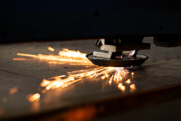 close-up laser cutting of metal on a CNC machine, at a large machine-tool plant in the center of the country