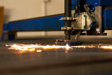close-up laser cutting of metal on a CNC machine, at a large machine-tool plant in the center of the country