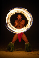 Male Fire dancer with illuminated spinning flaming torch - obrazy, fototapety, plakaty