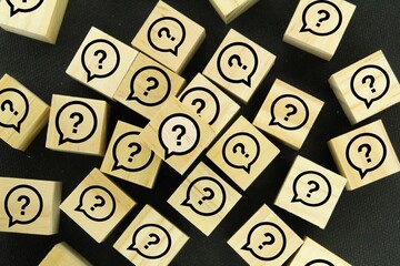 wooden cubes with question mark icons. the concept of questions and answers