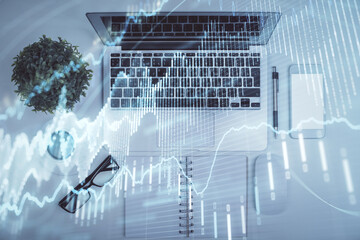 Multi exposure of forex chart drawing over table background with computer. Concept of financial research and analysis. Top view.