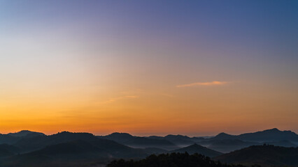 Naklejka premium sunset over the mountains in the morning with colorful orange sunrise