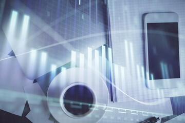 Fototapeta premium Multi exposure of forex graph hologram over desktop with phone. Top view. Mobile trade platform concept.