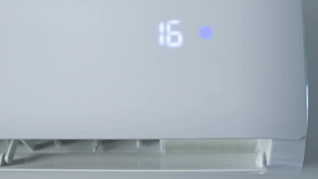 Adjusting temperature on air conditioner, Working air conditioner for comfort temperature in home at hot summer, cooling air in the room