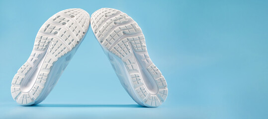 The white sole of sports sneakers. A couple of white sneakers.