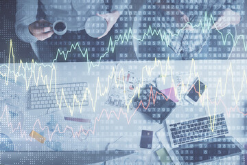 Obraz premium Double exposure of man and woman working together and financial chart hologram drawing. market analysis concept. Computer background. Top View.