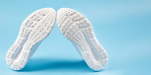 The white sole of sports sneakers. A couple of white sneakers.