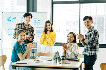 Group of asian young creative happy enjoy laugh smile and great success emotion teamwork people business startup entrepreneur casual brainstorm business meeting office background