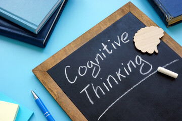 Cognitive thinking handwritten on the blackboard and brain.