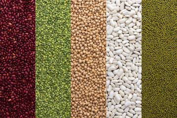 Different types of legumes, chickpeas and mung beans, white and red beans and green peas , top view
