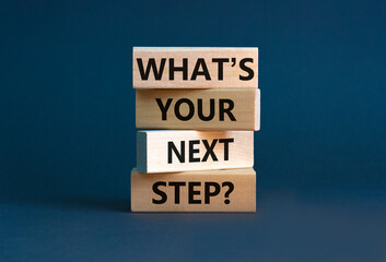 What is your next step symbol. Concept words What is your next step on blocks. Beautiful grey table grey background. What is your next step business concept. Copy space.