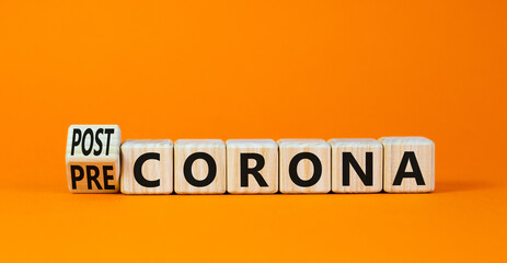 Covid-19 post or pre corona symbol. Turned wooden cubes and changed concept words Pre corona to Post corona. Beautiful orange background. Covid-19 pandemic post or pre corona concept. Copy space.
