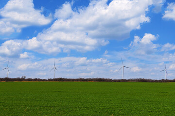 Fototapeta na wymiar green farmland field wind turbine farm renewable energy environmental power turbines