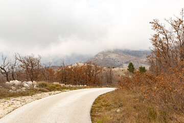 Obraz na płótnie Canvas Rural road in balkan mountains. Dalmatia region, Croatia.