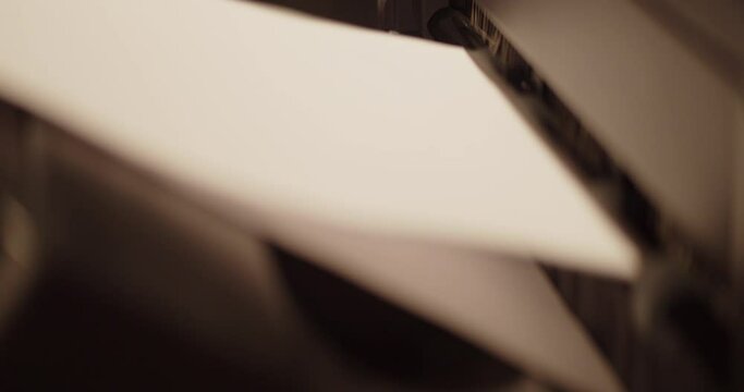 Close up view of papers coming out of the printer in the office. 4K.