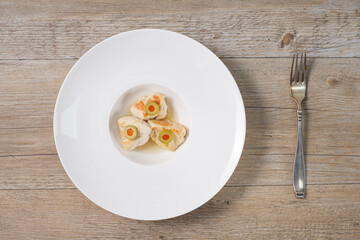 Chicken with green olives on wooden table