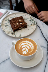 Piece of chocolate brownie and coffee.