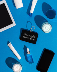 Skin care cosmetics protecting from gadgets blue light on blue background