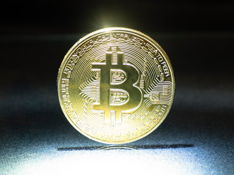 btc gold coin on lighting, bitcoin cryptocurrency closeup