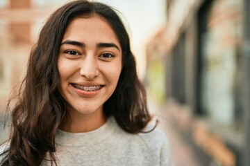 Young middle east girl smiling happy standing at the city.