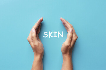 Word: skin in human hands. Symbol of protection of human skin from ultraviolet rays