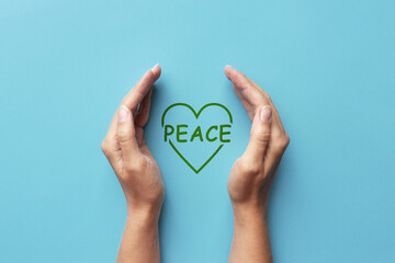 The word peace is in the hands of man. Symbol of protection of peaceful life
