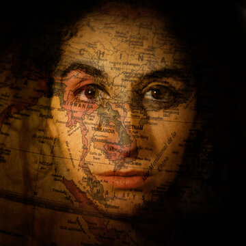 A woman with a world map projected over her face